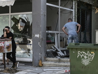 A man looks at a damaged shop following a strong blast in Thessaloniki on July 26, 2025. A