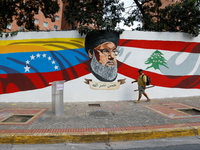 A man walks by a mural painted by the 
