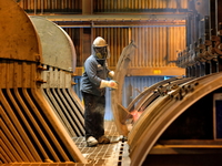 Alcoa Inc. employee Jerry Rivers opens an electrolytic cell to change the carbon anode at