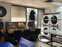 Casino games seen at Duds n' Suds laundromat in Reno, Nevada, with washing machines in background