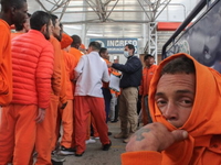 Colombian inmates wait to be registered by immigration agents after being deported from Ec