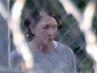 Ghislaine Maxwell is seen behind razor wire in prison