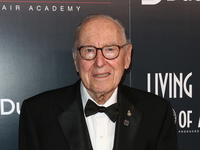 JIm Lovell in a suit smiling