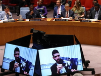 Members of the United Nations Security Council listen as Ilay David, brother of hostage Evyatar David, and holds up a photo of his brother in captivity as he speaks during a meeting called by Israel. 