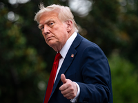 President Donald Trump walks on the South Lawn of the White House after arriving on Marine