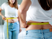 Woman measuring waist