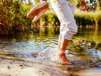Woman wading in shallow water